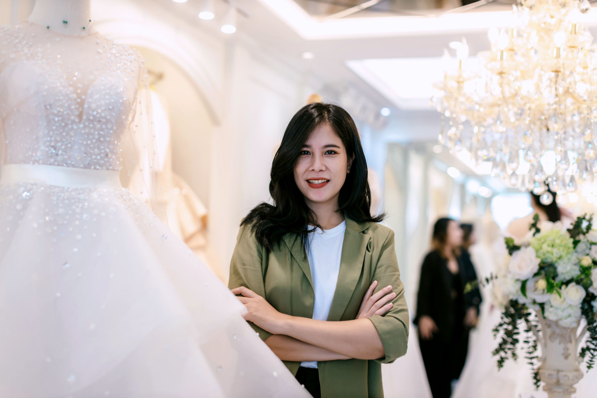 Female bridal store owner work in wedding studio shop. Owner Of Bridal Wedding Dress Shop Work in shop. Designer woman working wedding dress in store.
